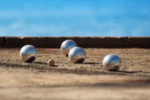 Plusieurs boules de pétanques sur un terrain